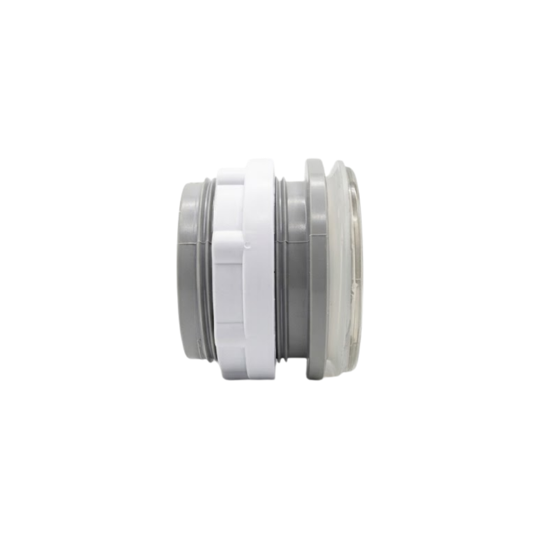 Horizontal side profile view of an assembled Artesian 2-inch Xylex/PVC light lens, displaying the front clear lens face, translucent gasket, threaded grey body, and white lock nut.