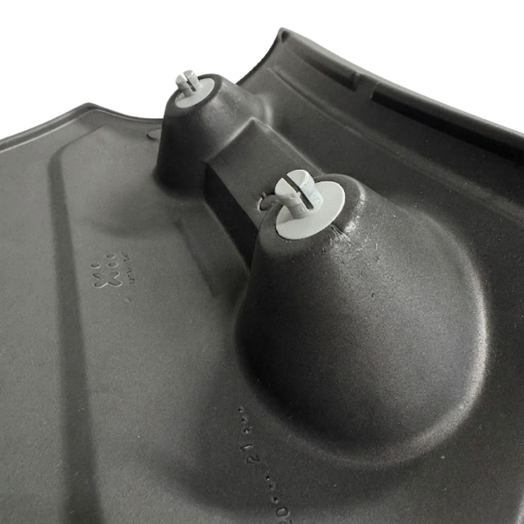 Close-up angled view of the reverse side of a charcoal black replacement Elite corner headrest pillow for an Artesian Spas hot tub, highlighting the two grey split-peg snap-in mounting fasteners and molded rear structure.