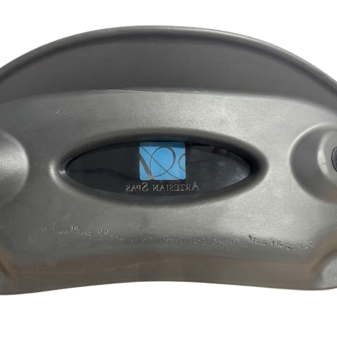 Rear view of a grey curved foam replacement headrest pillow for an Artesian Spas hot tub, showing the central oval cutout window displaying the reverse side of the translucent blue logo dome emblem and molded factory serial numbers.