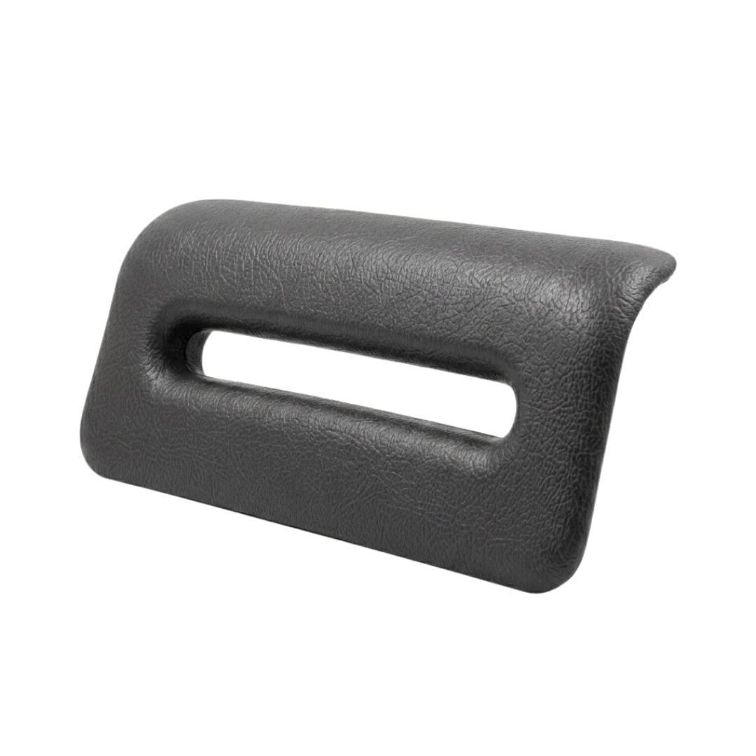 Side angle view of an Artesian Spas Island series replacement 8-inch waterfall headrest pillow in dark charcoal gray, showing its curved ergonomic profile and open slot.
