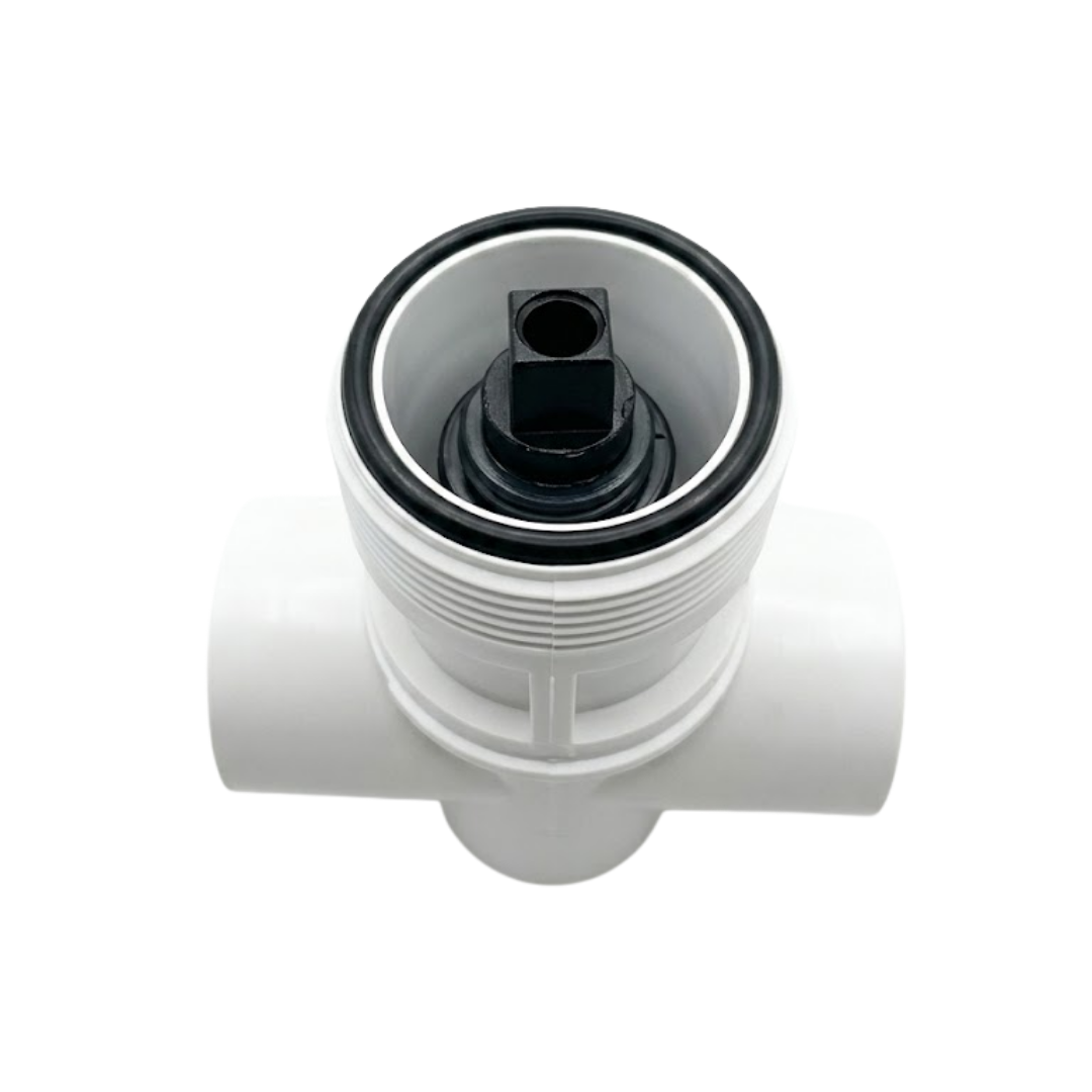 A top down view looking into a white Balboa HydroAir 3 way diverter valve body showing the upper black rubber O ring and the square internal black plastic stem plunger