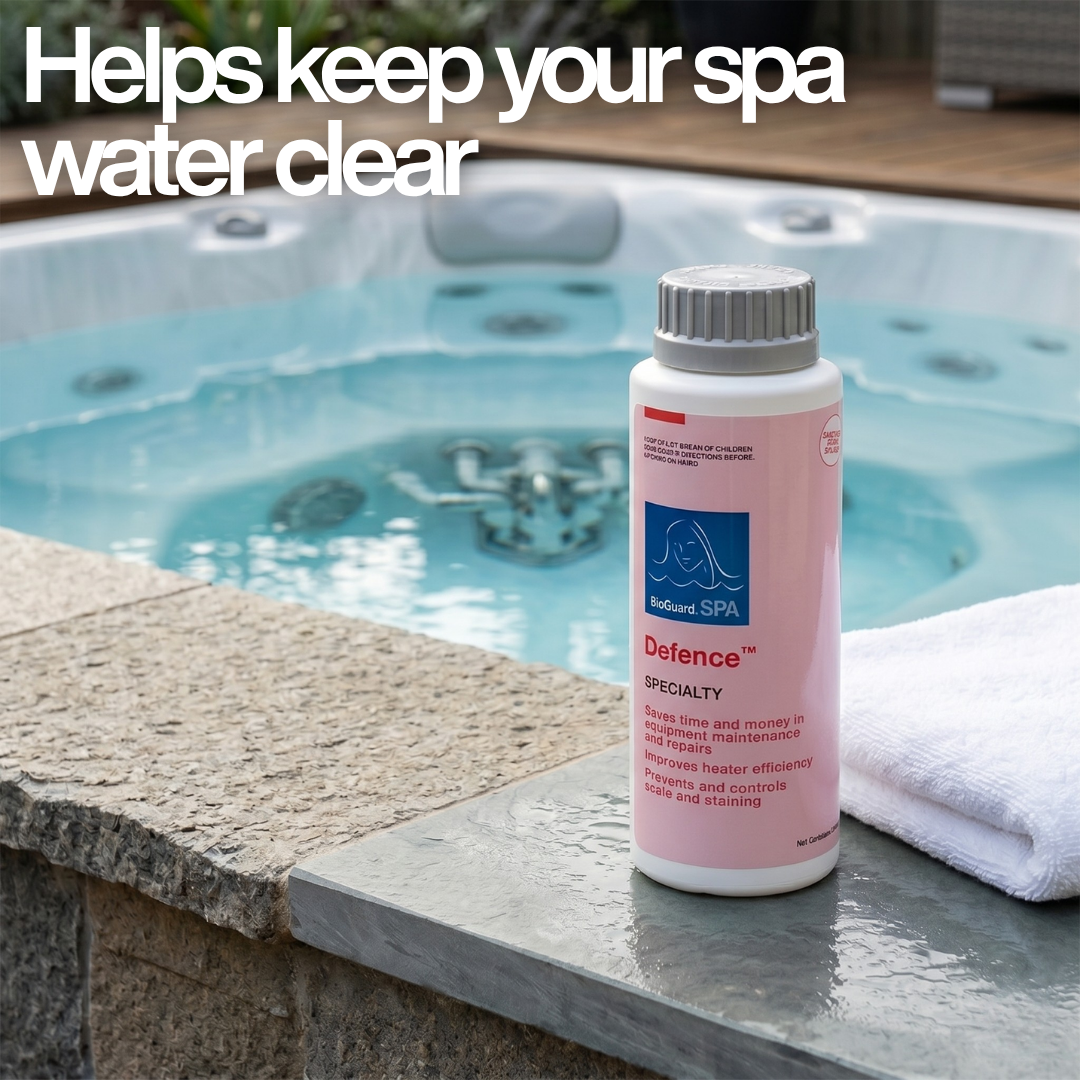 A bottle of BioGuard SPA Defence stain and scale control specialty treatment sitting on the edge of a clear blue hot tub