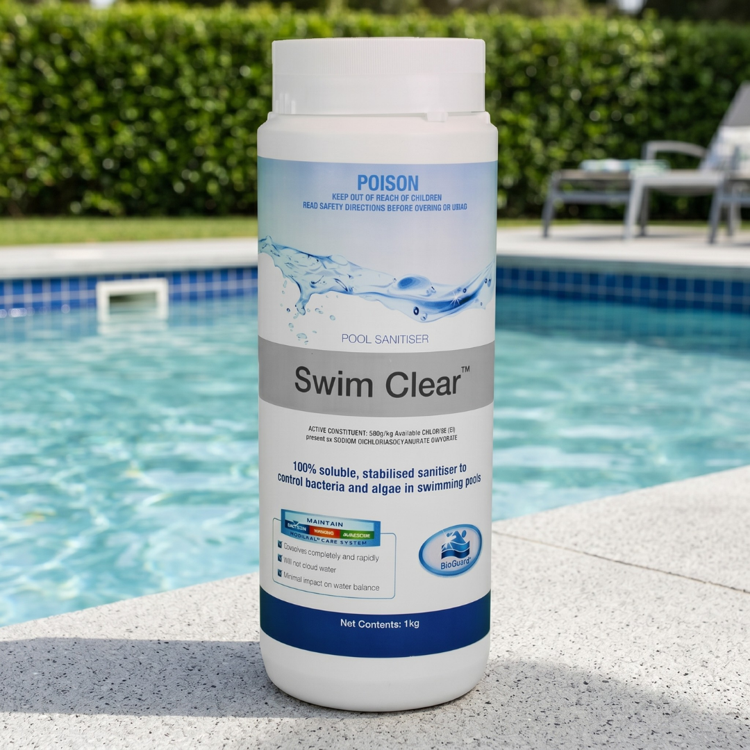 A 1kg bottle of BioGuard Swim Clear pool sanitiser sitting on a concrete pool edge, providing 100% soluble and stabilised chlorine to control bacteria and algae in outdoor pools.