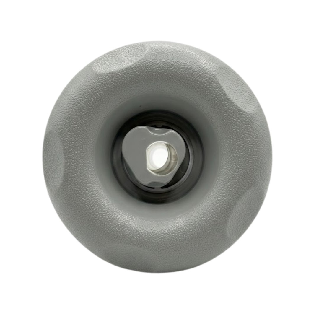 Direct overhead front view of a Cyclone Adj Swirl Emerald Large Face spa jet internal insert, featuring a textured light grey scalloped bezel and a central grey rotational swirl nozzle.