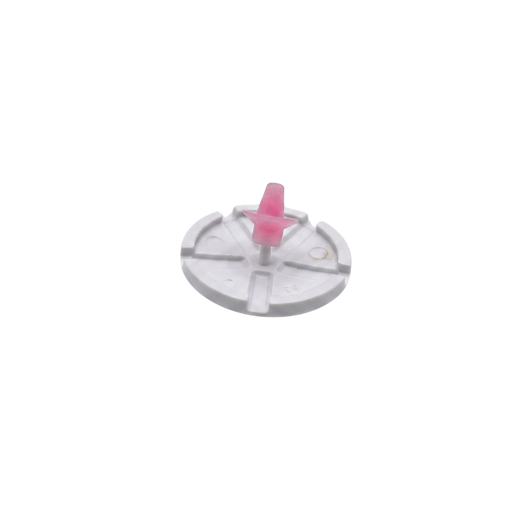 A small pink replacement air injector cone mounted onto a circular white plastic air injector cover backing plate for Edgetec spa jets