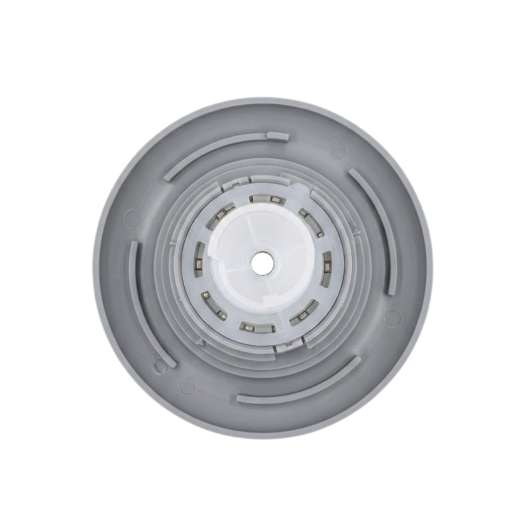Direct overhead bottom-up view of the rear of a grey HydroAir adjustable VSR spa jet internal insert, showing the backside of the circular outer flange and concentric mounting rings.