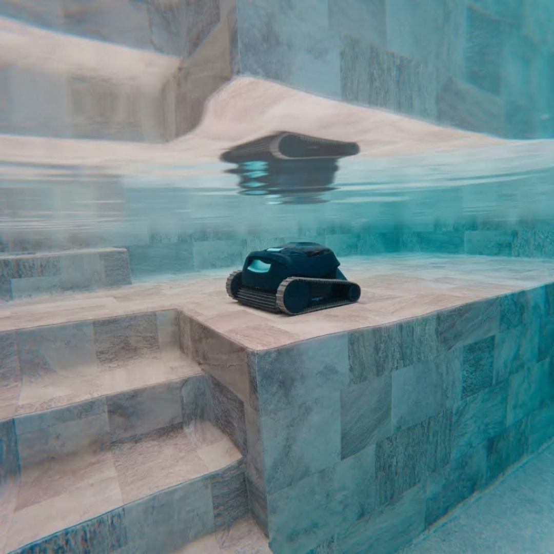Underwater shot of the Maytronics Dolphin Liberty 200 robotic pool cleaner resting on a wide, tiled pool step bench near built-in stairs.