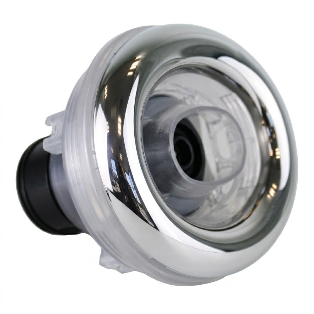 Three-quarter front profile view of an Ovo Swim With Metal 2in SX 12in artesian spa jet insert, showing its reflective metallic oval face bezel, clear internal nozzle barrel assembly, and black rear stem.