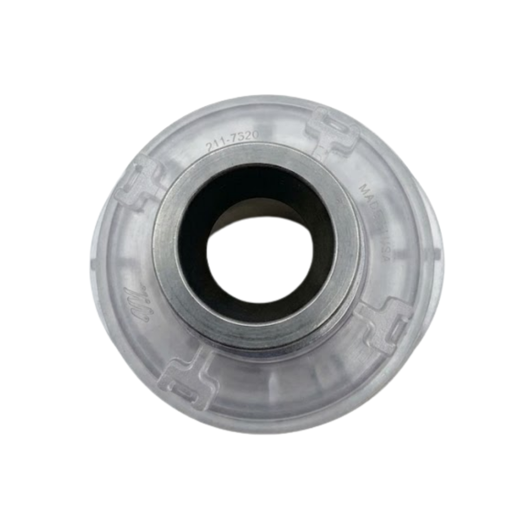 Direct overhead bottom-up view of the rear assembly on an Ovo Swim With Metal 2in SX 12in Artesian spa jet insert, showing the central dark port, metallic collar, and clear plastic body casing stamped with part number 211-7320.
