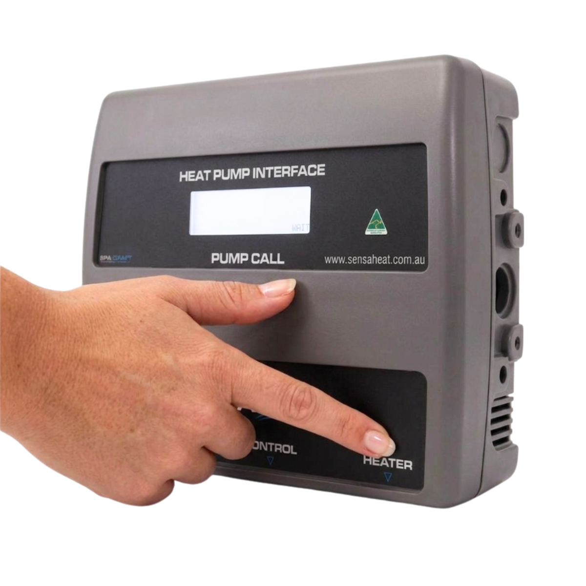 A hand pressing a button on the front panel of a grey Sensaheat Heat Pump Interface pool controller unit, demonstrating product operation and size scaling.