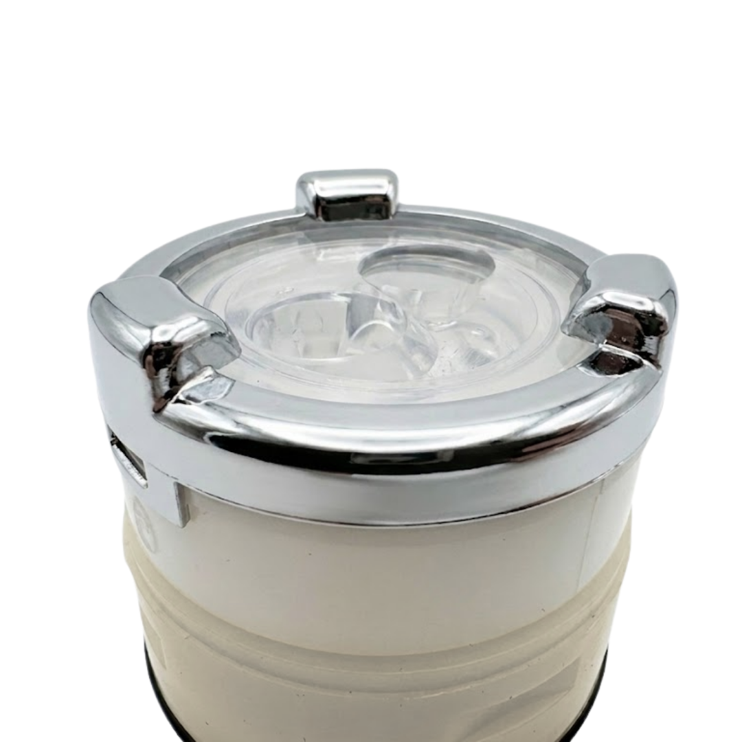 Close-up view of the top face of a swirl spa jet internal insert, showcasing a polished chrome bezel ring with three raised gripping tabs, a transparent plastic face cover, twin rotational jet nozzles, and an off-white lower housing.