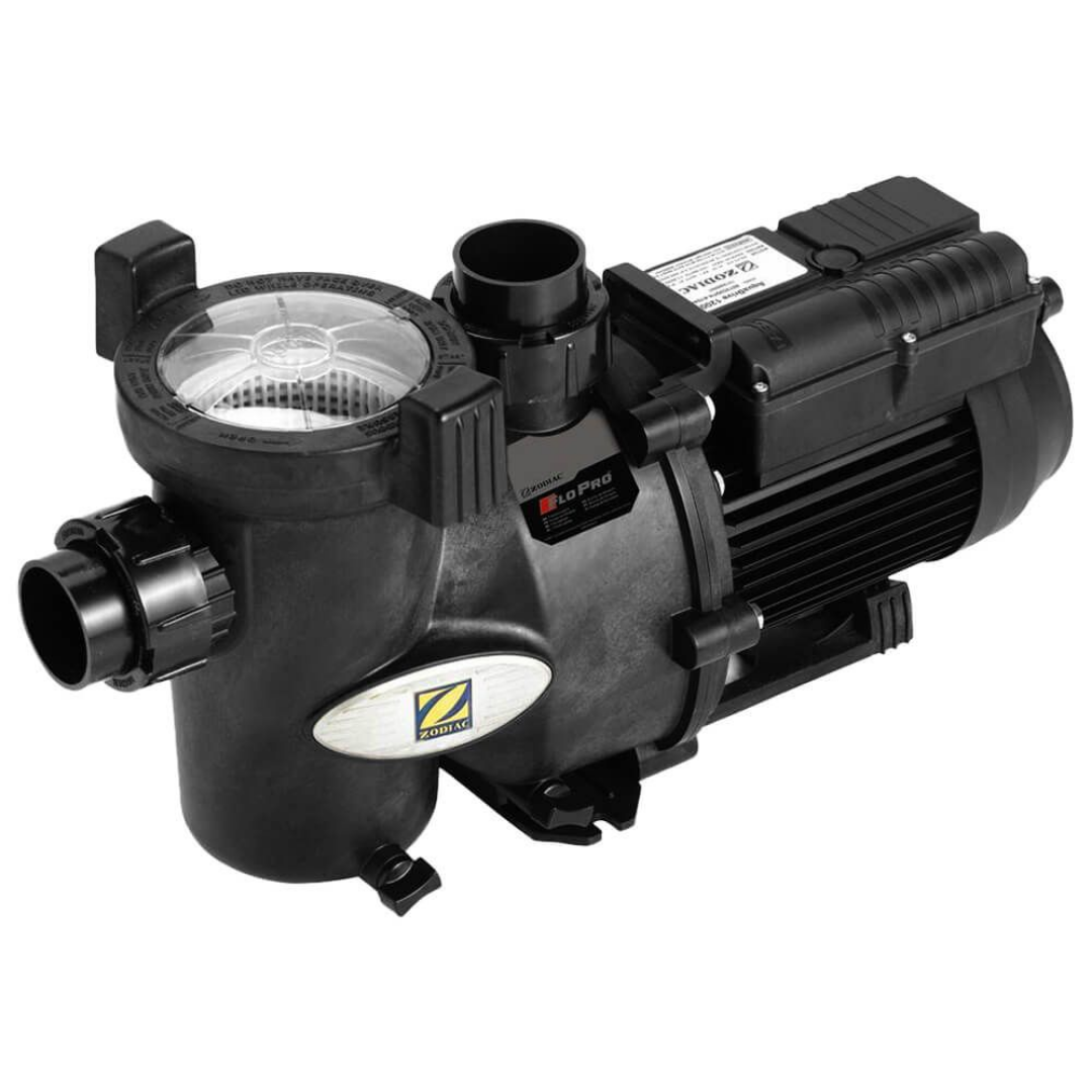 High-angle three-quarter studio shot of a Zodiac FloPro SS 1.0 HP pool pump, displaying the clear viewing lid, strainer basket, silver Zodiac logo emblem, black quick-connect unions, and rear motor unit isolated on white.
