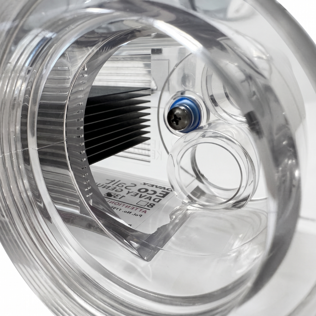 Interior close-up look through a clear threaded port of a Davey EcoSalt replacement chlorinator cell, showing the stacked titanium plates and the internal screw connection for the top earthing post terminal.