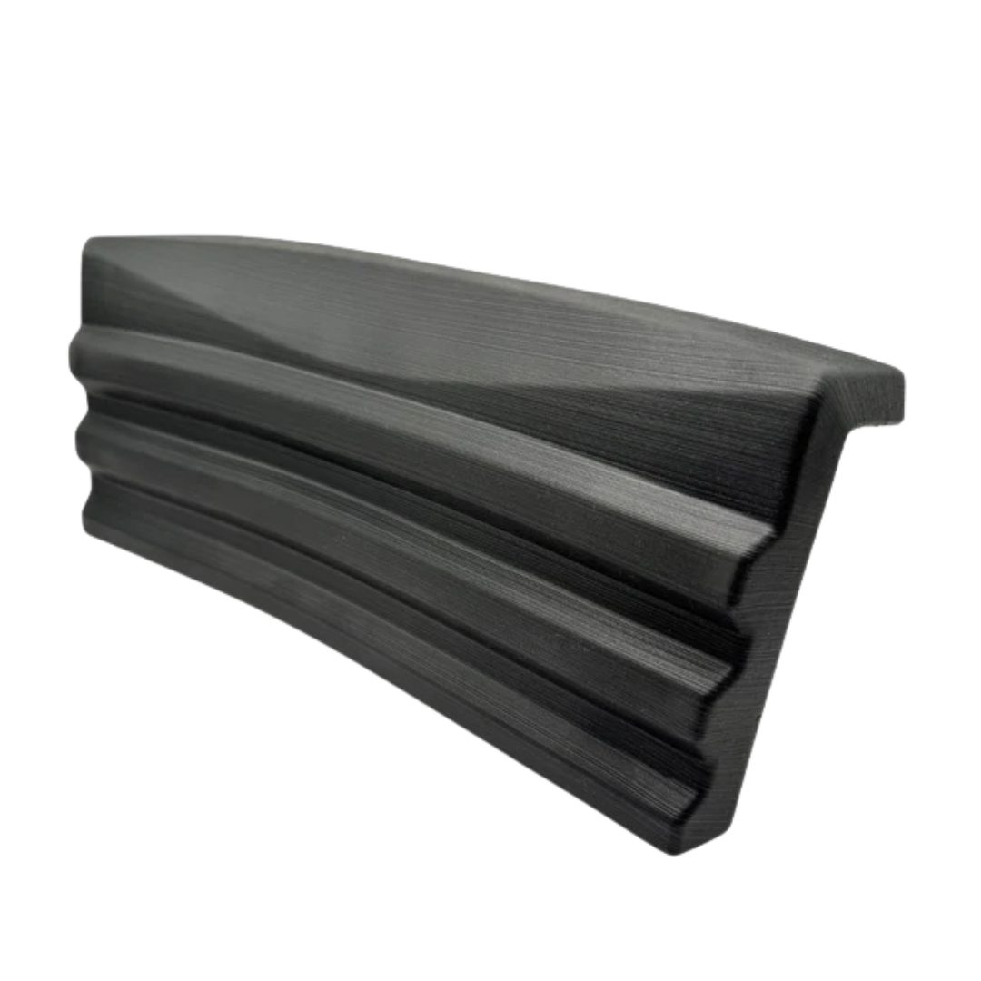 Side angle perspective view of a charcoal grey textured replacement headrest pillow for an Artesian Elite lounge spa seat, highlighting its angled profile design on a white background.