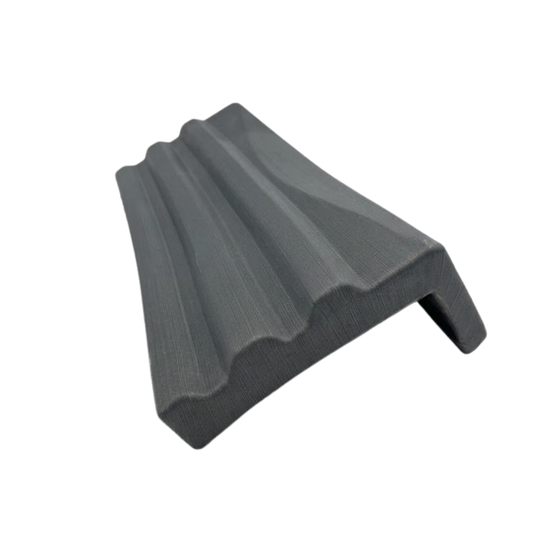 High-angle top-down perspective of a charcoal grey textured replacement headrest pillow for an Artesian Elite lounge spa seat, showcasing the ribbed contour ridges on a white background.