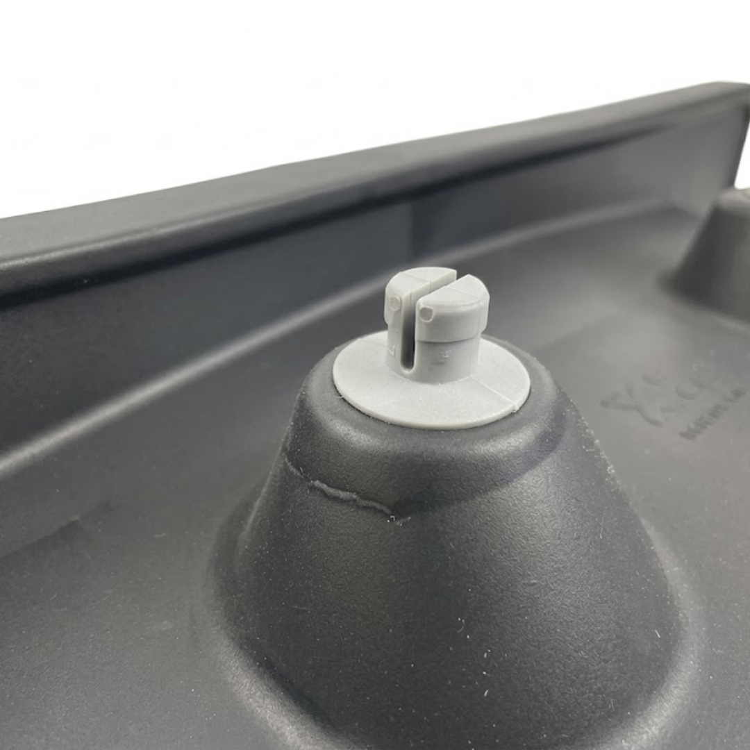 Macro close-up of a grey plastic snap-in mounting fastener pin on the back of an Artesian Elite lounge spa headrest pillow replacement.