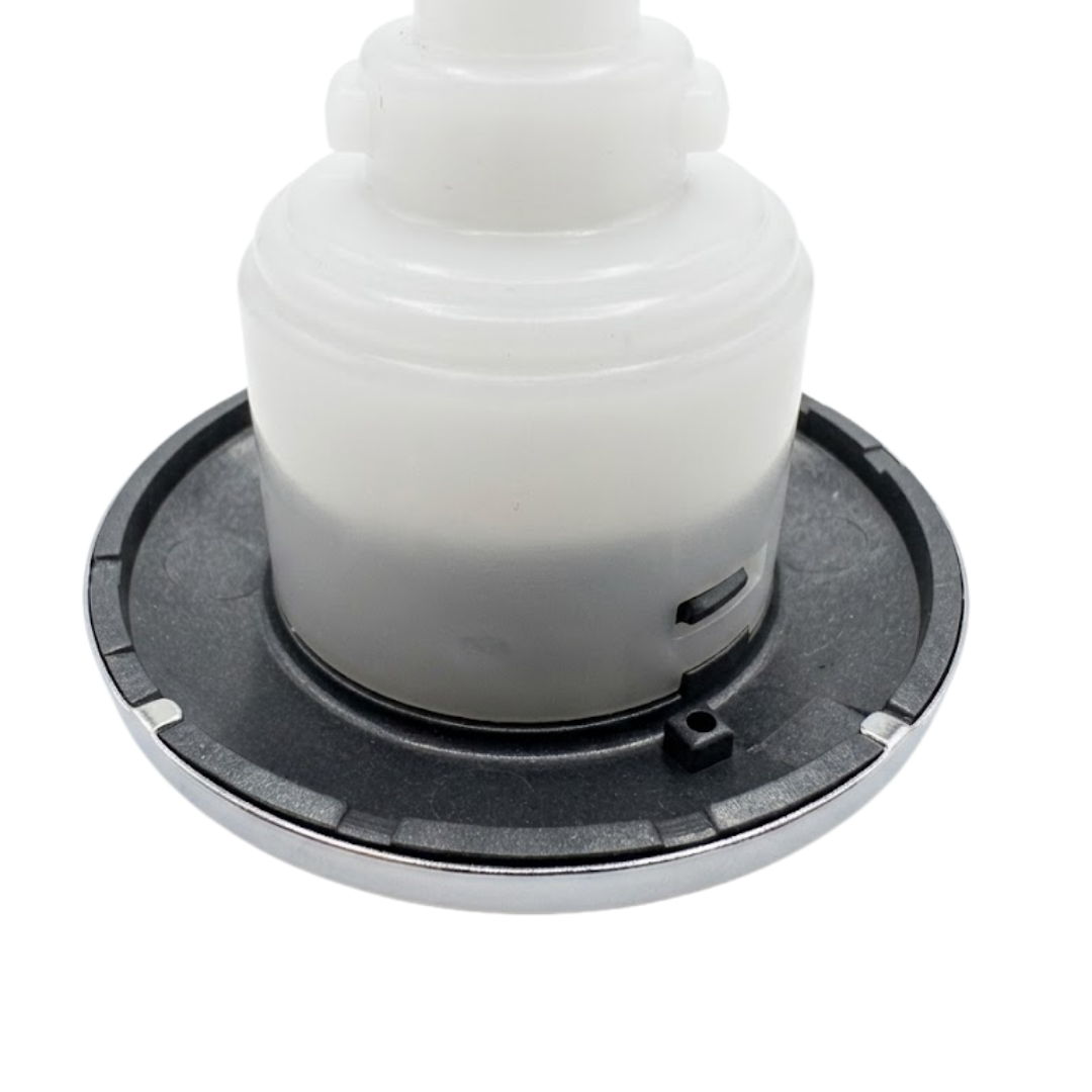 Close-up angled view of the rear face flange housing on an Artesian C-Helix 3 ROTO SS spa jet insert, showing the dark grey back flange ring, small indexing tab, and white translucent body casing.