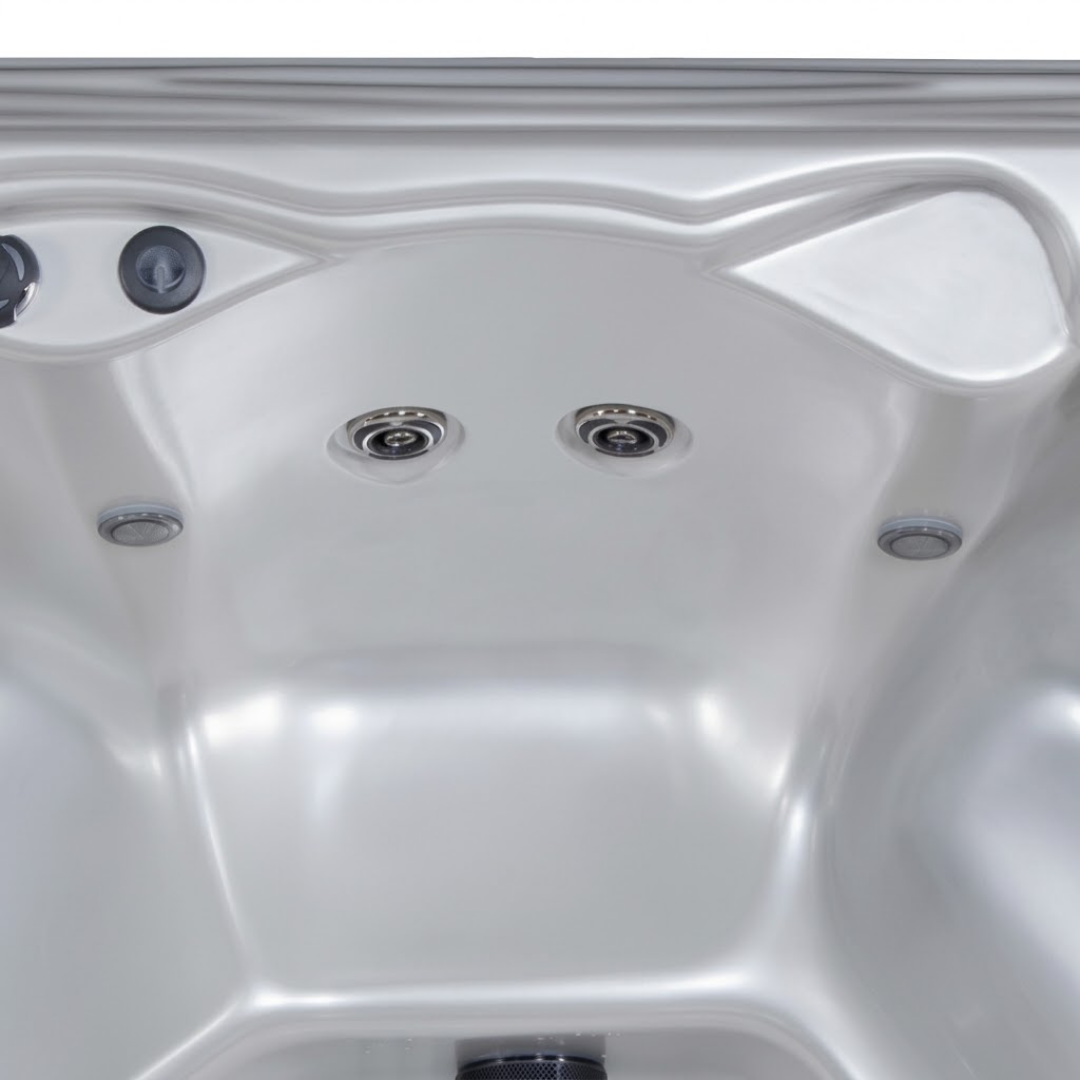 Wide view of two Artesian C-Helix 3 ROTO SS spa jets installed inside the wall of a white acrylic hot tub shell.