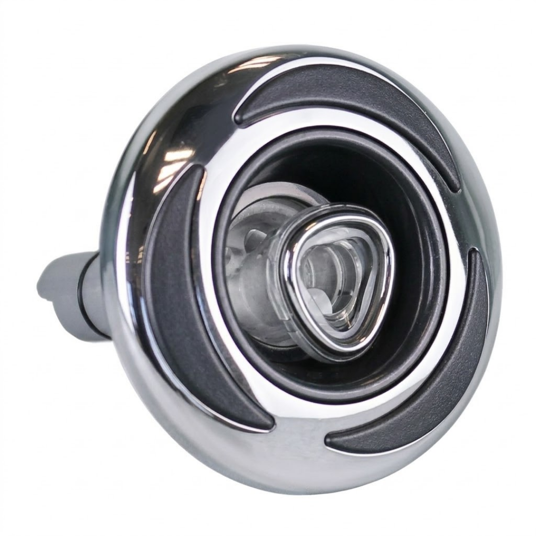Three-quarter angled view of an Artesian C-Helix 3 ROTO SS spa jet insert, highlighting the polished stainless steel bezel with dark curved grip accents, central clear triangular roto nozzle, and extending rear stem.