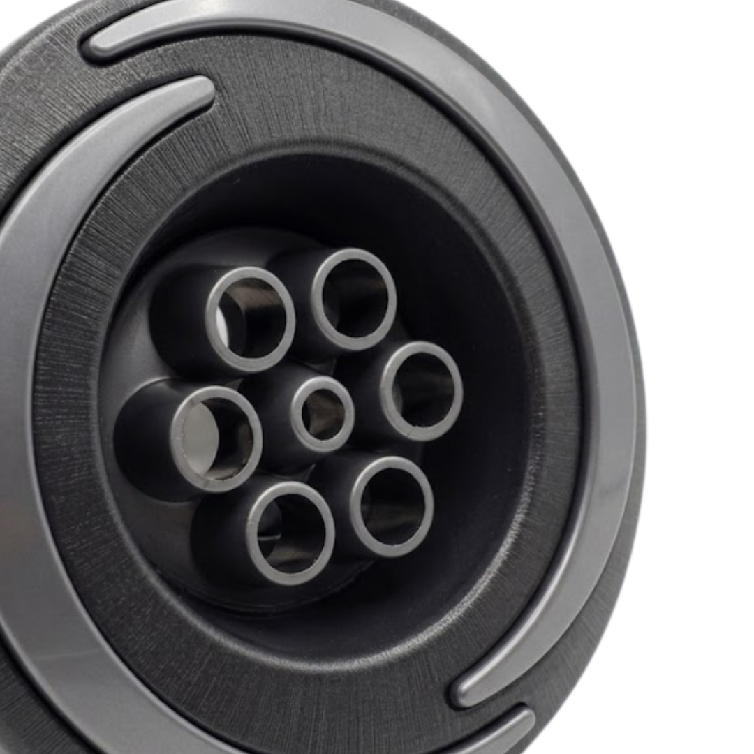 Close-up angled view of the central six-port massage nozzle cluster on an Artesian Halo 3 Massage plastic spa jet insert, showing the textured black bezel with grey swirl accent detailing.