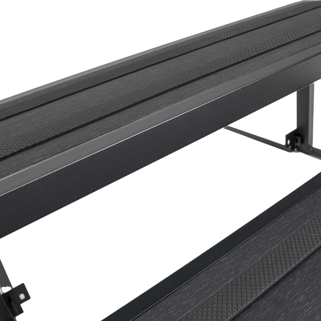 Close-up detail of black Artesian modular aluminium spa steps highlighting the non-slip textured safety grip treads.