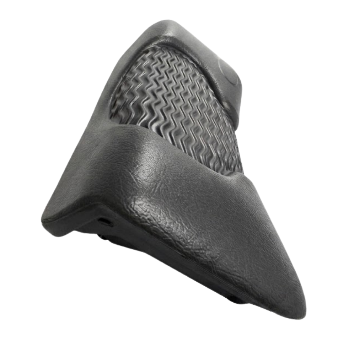 Side perspective view of a dark charcoal black foam replacement lounger headrest pillow for an Artesian hot tub, highlighting its contoured wedge shape, textured finish, and wavy-ridge insert details against a white background.