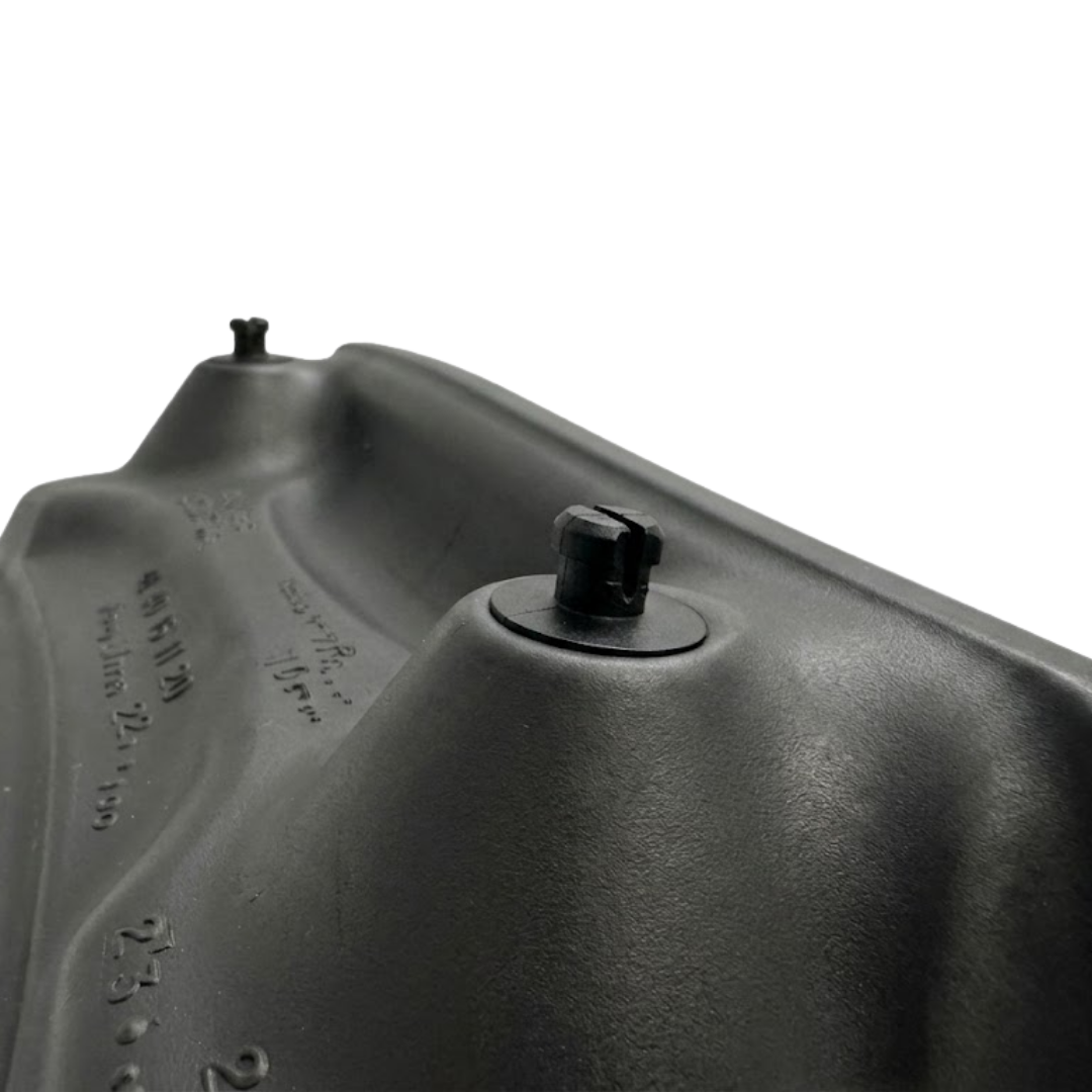 Close-up structural view of the reverse side of a dark charcoal black foam replacement lounger headrest pillow for an Artesian hot tub, focusing on the split black snap-in fastener peg.