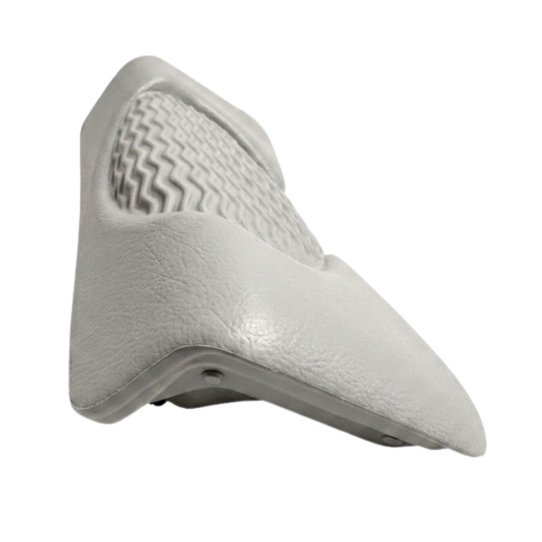 Side perspective view of a light grey foam replacement lounger headrest pillow for an Artesian hot tub, highlighting its contoured wedge shape, textured leather-grain finish, and wavy-ridge insert details against a white background.