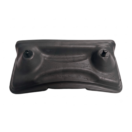 Rear view of a dark charcoal black foam replacement lounger headrest pillow for an Artesian hot tub, displaying the back contour structure with two black mounting pins and molded factory date grid markings.