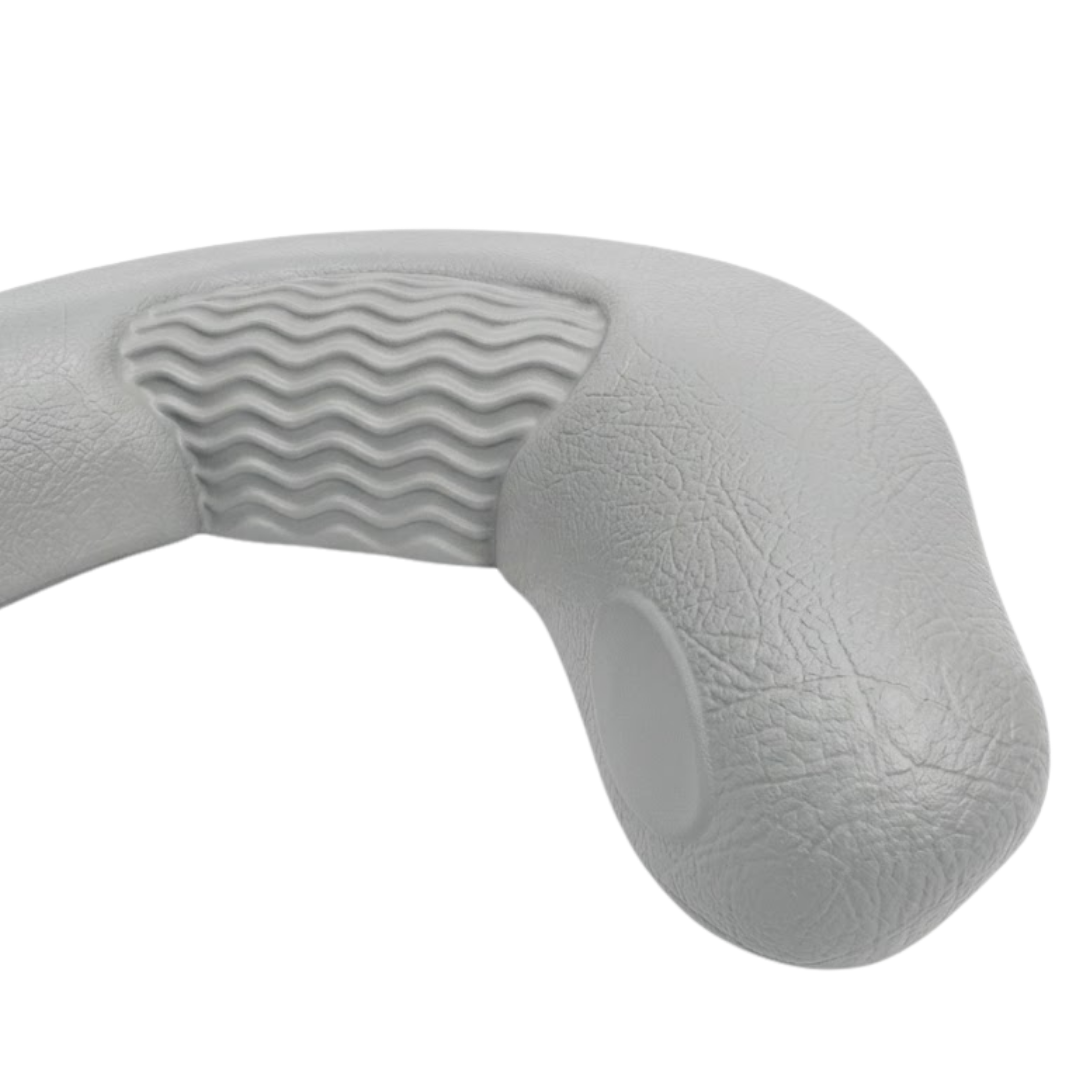 Close-up texture view of a grey foam replacement neck headrest pillow for an Artesian hot tub, focusing on the faux-leather grain finish and the wavy center cushion pattern.