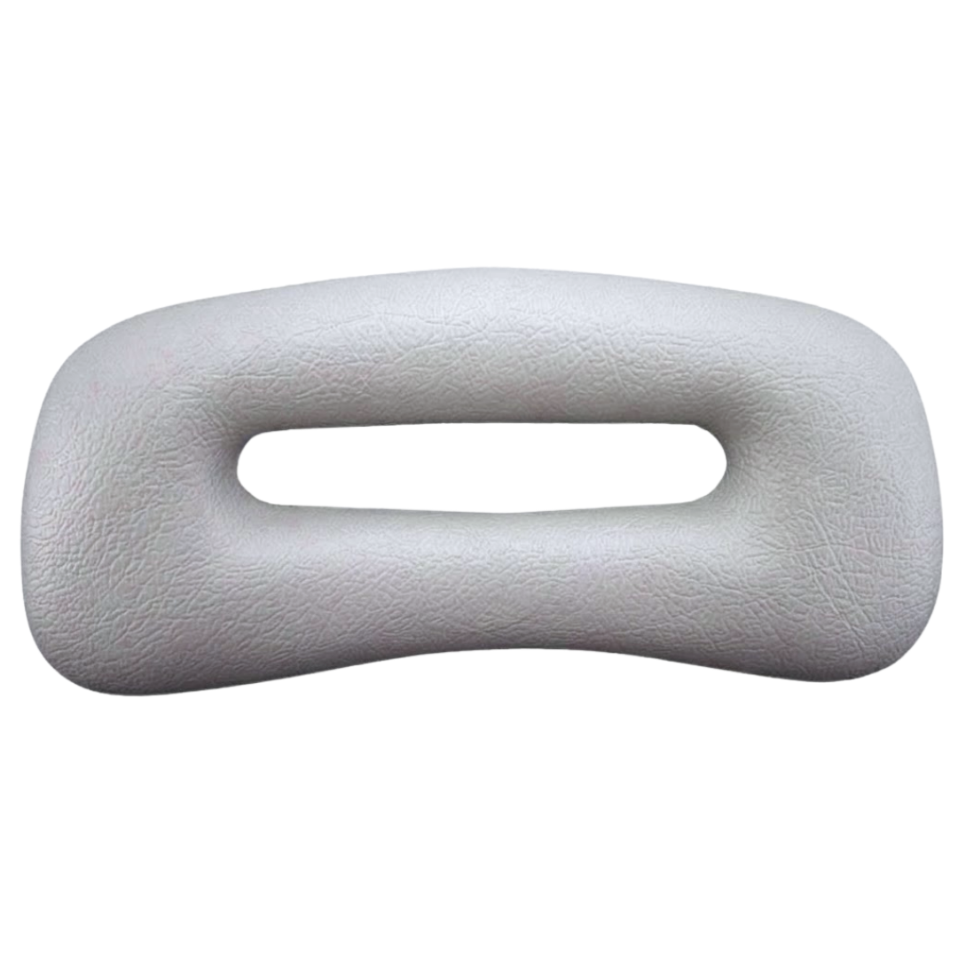 Front view of a grey rectangular replacement foam headrest pillow for an Artesian hot tub, featuring an elongated oval center cutout slot and a textured faux-leather surface against a white background.