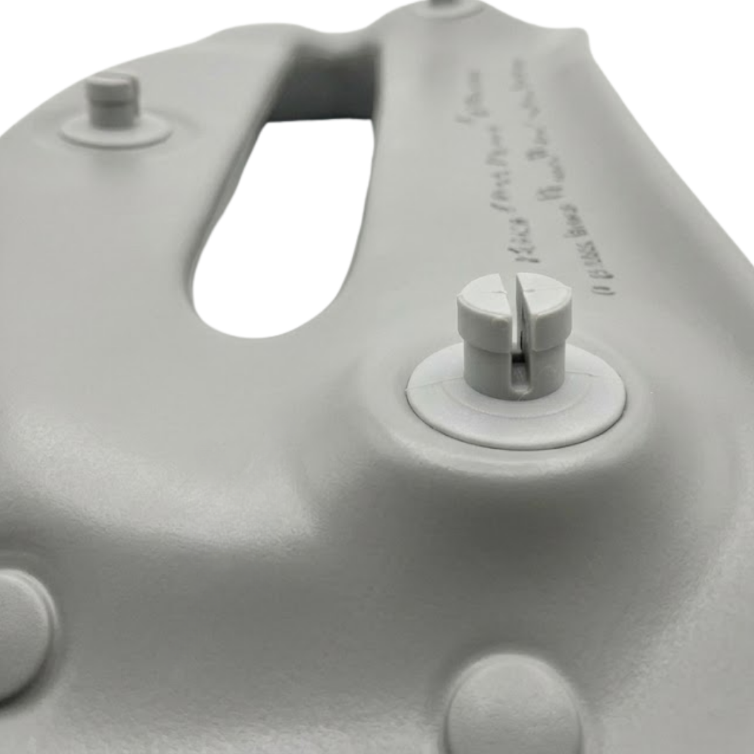 Close-up structural view of the reverse side of a grey foam replacement headrest pillow for an Artesian hot tub, focusing on the split plastic snap-in mounting pins used for installation.