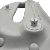 Close-up structural view of the reverse side of a grey foam replacement headrest pillow for an Artesian hot tub, focusing on the split plastic snap-in mounting pins used for installation.