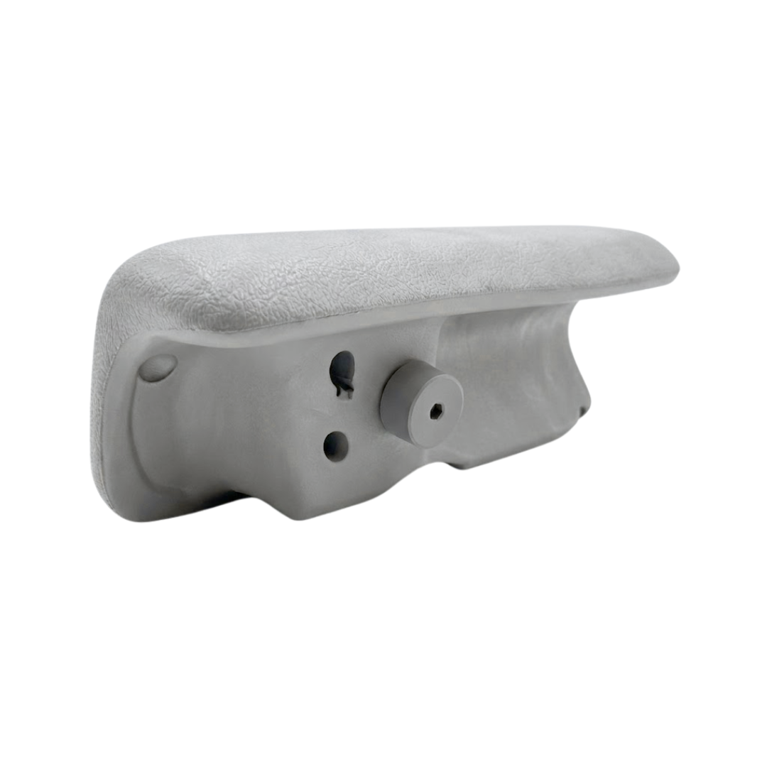 Underneath profile angle of a grey foam replacement wrap-around headrest pillow for an Artesian spa, detailing the textured upper cushion surface and the lower mounting assembly with a prominent alignment peg.