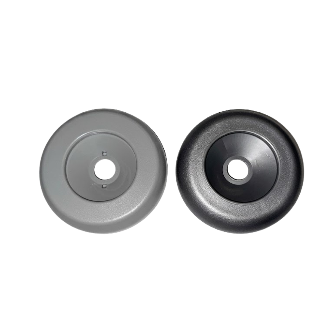 A top down side by side color comparison of the 2 inch Artesian Spas diverter valve replacement caps showing the light grey finish on the left and the dark graphite grey finish on the right