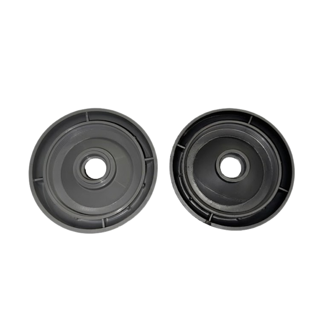 A top down overhead comparison view of the undersides of two 2 inch Artesian Spas diverter valve replacement caps showing the light grey threads on the left and dark graphite grey threads on the right