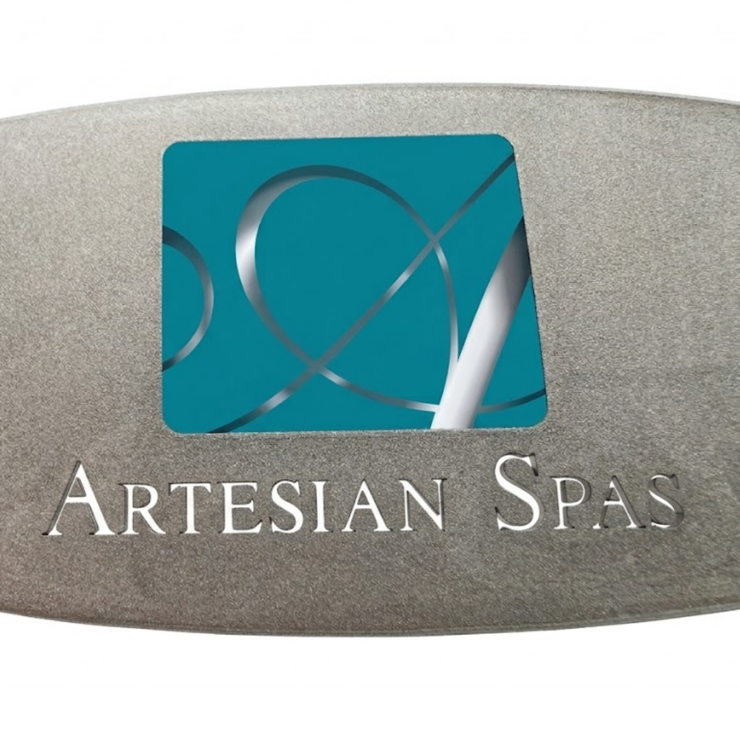 Macro close-up shot of a metallic silver replacement resin dome label for an Artesian Spas hot tub headrest pillow, focusing on the stylized teal square "A" logo and engraved style "ARTESIAN SPAS" branding text.