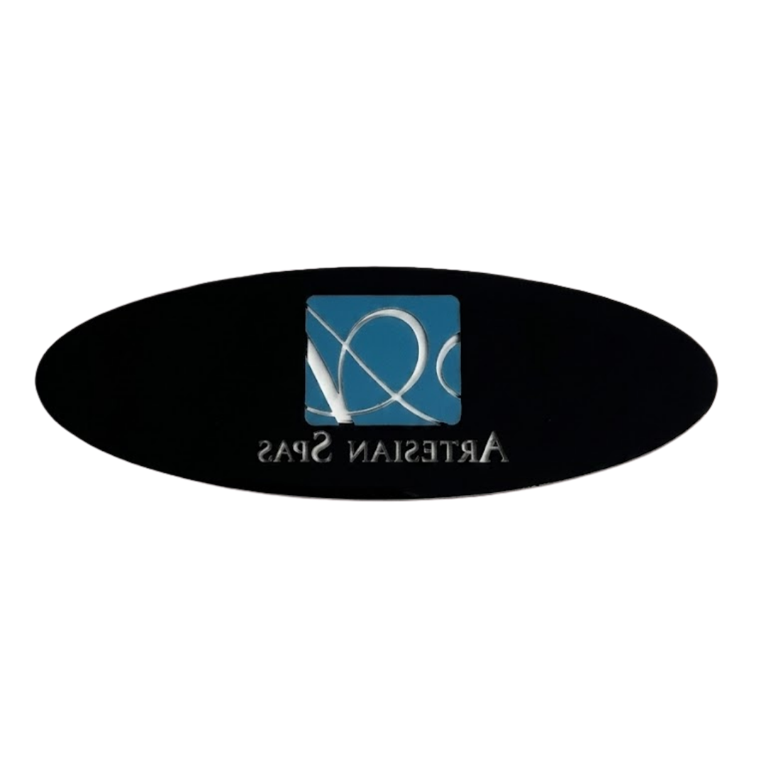 Rear view of an oval replacement resin dome label insert for an Artesian Spas headrest pillow, showing the black adhesive backing with the mirrored teal logo silhouette and reversed "ARTESIAN SPAS" text.