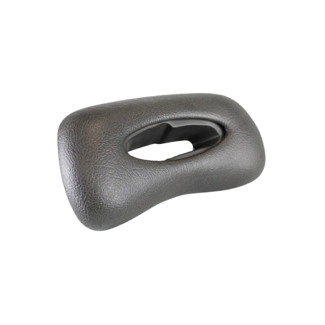 Side angle view of an Artesian Spas Platinum Elite series replacement 11-inch headrest pillow in dark charcoal gray, displaying its curved ergonomic shape and central oval cutout.