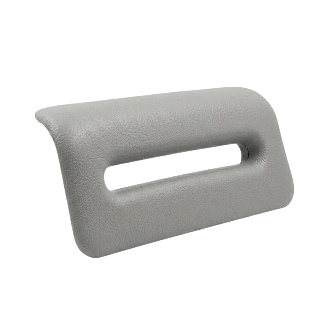 Side angle view of an Artesian Spas South Seas and Tropic Seas series replacement 8-inch waterfall headrest pillow in light gray, showing its curved ergonomic profile and open slot.