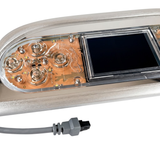 Close-up view of an Artesian Spas TP800 Island Spas touchpad panel showing screen, internal button contacts, metallic bezel, and connector plug.