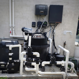 Complete pool equipment pad setup featuring an AstralPool Viron QL420 cartridge filter tank integrated with a Viron Connect automation controller box a gas heater pool pump and complex PVC valve manifold plumbing