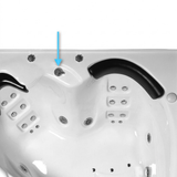 An installed top down view of a chrome Balboa HydroAir 3 way diverter valve pointed out by a blue arrow on the corner shell of a white acrylic spa bath
