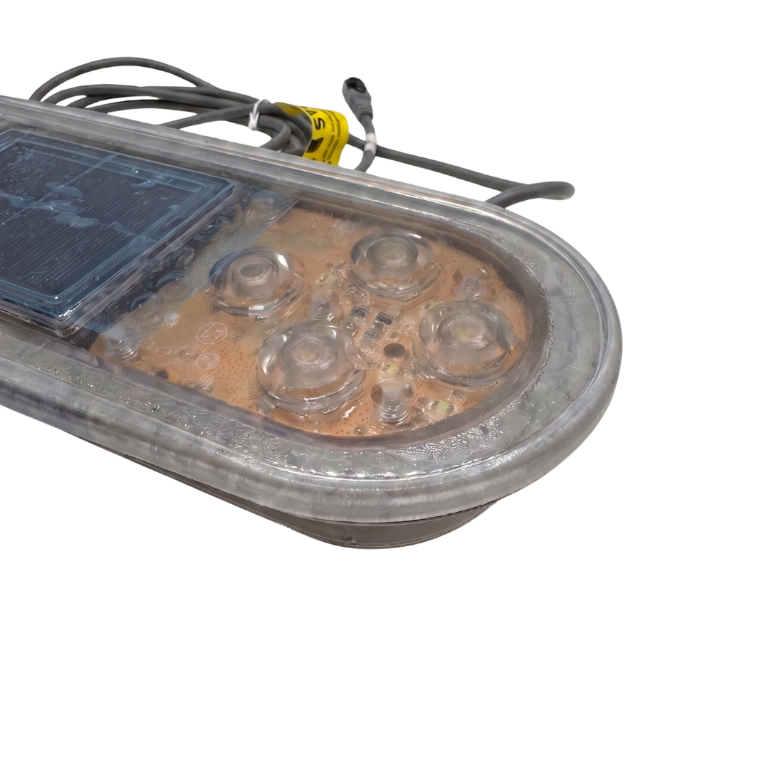 Front angled view of a Balboa TP800 TidalFit swim spa touchpad panel without its graphic overlay decal, showing the clear molded plastic button covers, internal circuit board components, and central digital LCD display window structure.