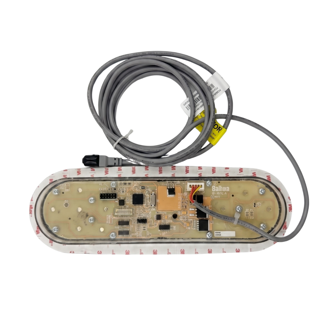 Rear view of an oval Balboa TP800 TidalFit swim spa touchpad controller, displaying the exposed printed circuit board inside a translucent housing, surrounded by a 3M adhesive mounting gasket, with a coiled grey connection cable and plug.