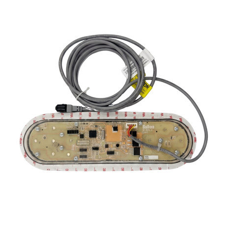 Rear view of an oval Balboa TP800 TidalFit swim spa touchpad controller, displaying the exposed printed circuit board inside a translucent housing, surrounded by a 3M adhesive mounting gasket, with a coiled grey connection cable and plug.