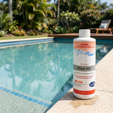 A 1-liter bottle of BioGuard Phos Kill phosphate remover sitting on the edge of a clean, blue backyard swimming pool.