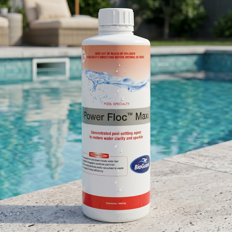 A 946ml bottle of BioGuard Power Floc Maxi concentrated pool settling agent standing on a stone ledge next to a clear swimming pool. The label shows the BioGuard logo and states that it restores water clarity and sparkle as a pool specialty flocculant.