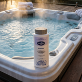 BioGuard SPA Armour 800g sanitiser and oxidiser bottle sitting on the edge of a steaming outdoor hot tub. This dual-action chemical restores sparkling clear water and controls bacteria in spa pools.