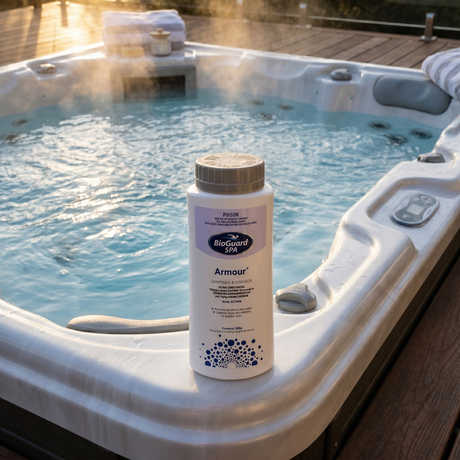 BioGuard SPA Armour 800g sanitiser and oxidiser bottle sitting on the edge of a steaming outdoor hot tub. This dual-action chemical restores sparkling clear water and controls bacteria in spa pools.